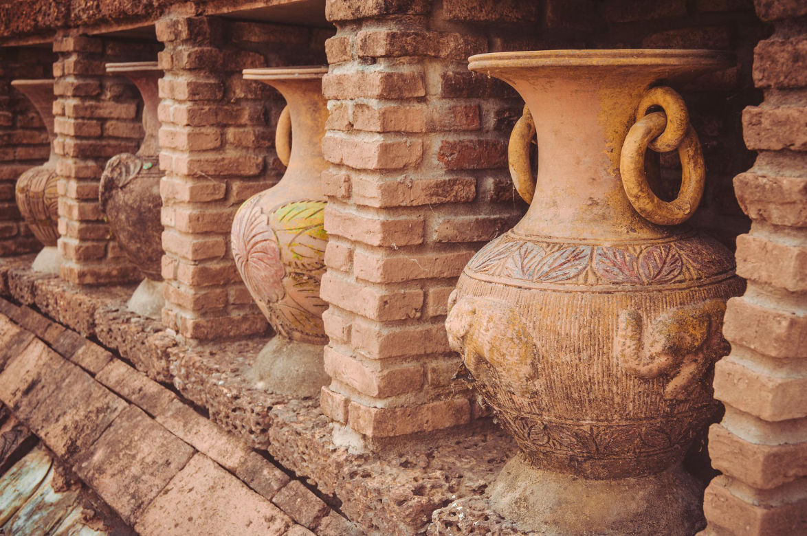 historic brown clay vases in brown stone temple