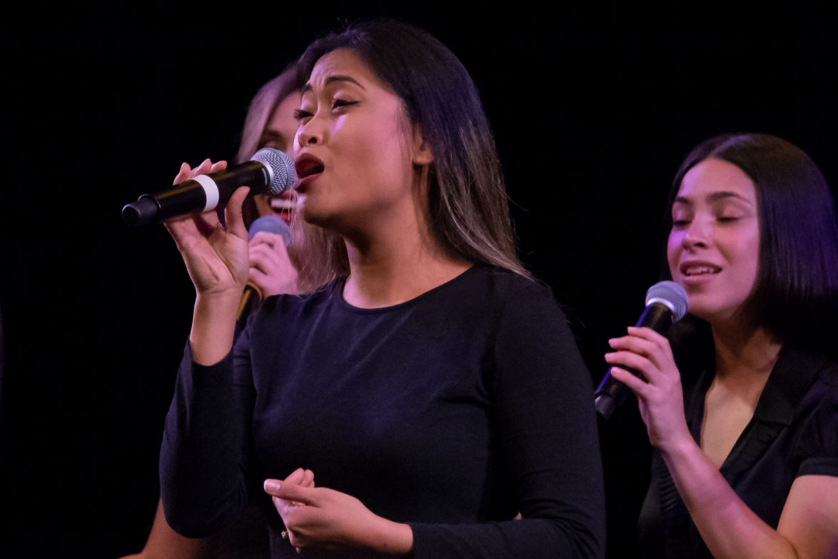 female student vocal jazz singers performing